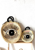 bolso de paja redondo con ojo bordado